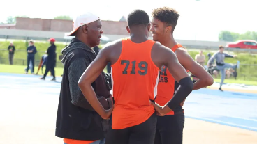 Track Coach Tyree Shine talks with High Jumpers Maurice Ware and Amil Upchurch during the Division I Regional track meet in Findlay