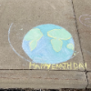7th Grade students celebrating earth day with sidewalk chalk drawings